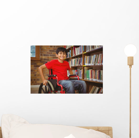 Portrait of boy sitting in wheelchair at library Wall Mural