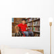 Portrait of boy sitting in wheelchair at library Wall Mural
