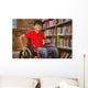 Portrait of boy sitting in wheelchair at library Wall Mural