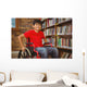 Portrait of boy sitting in wheelchair at library Wall Mural