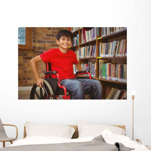 Portrait of boy sitting in wheelchair at library Wall Mural