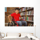 Portrait of boy sitting in wheelchair at library Wall Mural