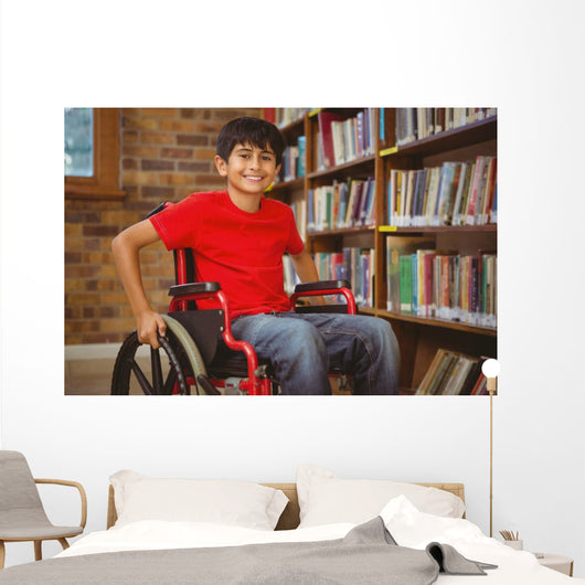 Portrait of boy sitting in wheelchair at library Wall Mural