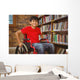 Portrait of boy sitting in wheelchair at library Wall Mural
