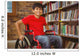Portrait of boy sitting in wheelchair at library Wall Mural