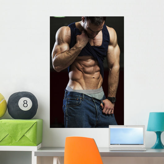 Bodybuilder showing off his abs Wall Mural