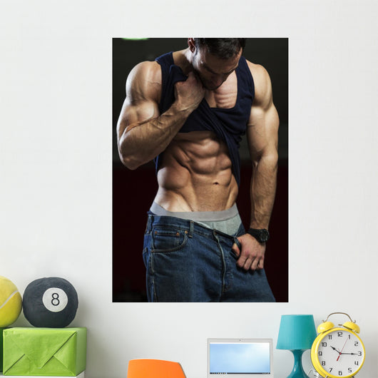 Bodybuilder showing off his abs Wall Mural