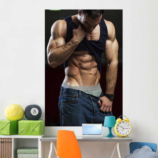 Bodybuilder showing off his abs Wall Mural