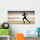 Composite image of pretty fit blonde jogging Wall Mural