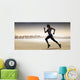 Composite image of pretty fit blonde jogging Wall Mural