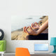 The woman meditating in a yoga pose on the tropical beach. Wall Mural