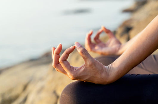 The woman meditating in a yoga pose on the tropical beach. Wall Mural