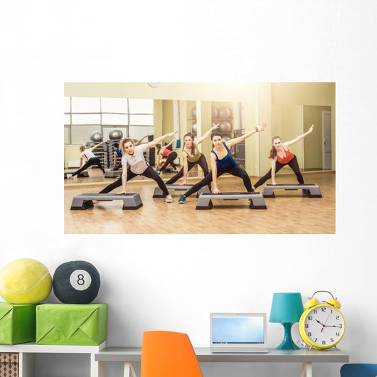 Group of women making step aerobics Wall Mural