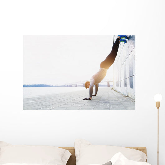 Young athlete is doing vertical push ups Wall Mural