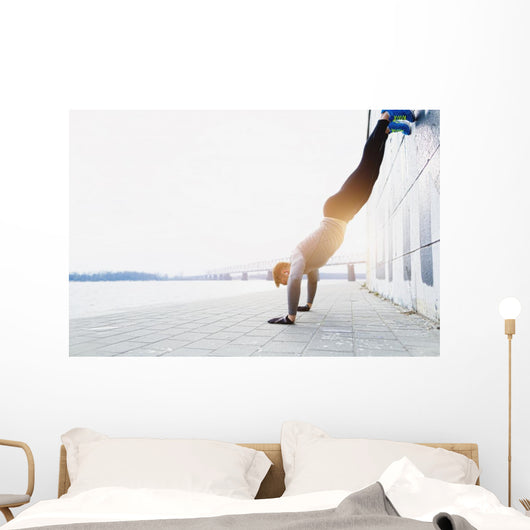 Young athlete is doing vertical push ups Wall Mural