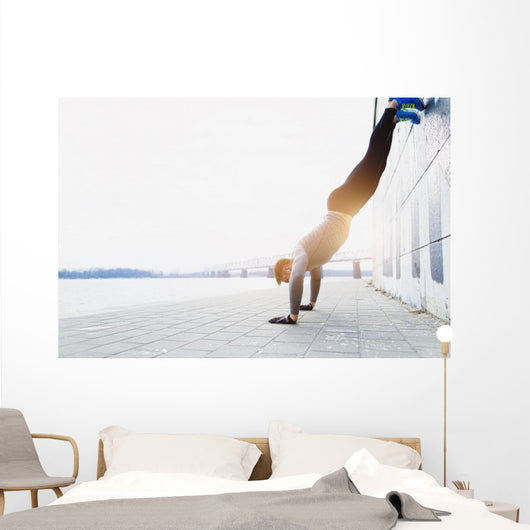 Young athlete is doing vertical push ups Wall Mural