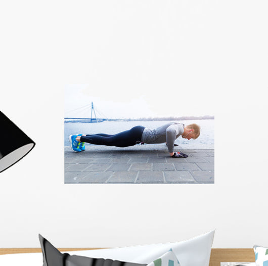 Young athlete is doing push ups Wall Mural