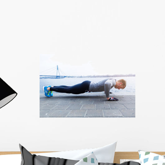 Young athlete is doing push ups Wall Mural