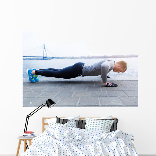 Young athlete is doing push ups Wall Mural