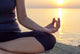 The woman meditating in a yoga pose on the tropical beach. Wall Mural