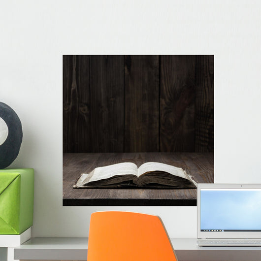 Image of an old Holy Bible on wooden background on a wooden background in a dark space Wall Mural