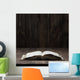 Image of an old  Holy Bible on wooden background on a wooden background in a dark space Wall Mural