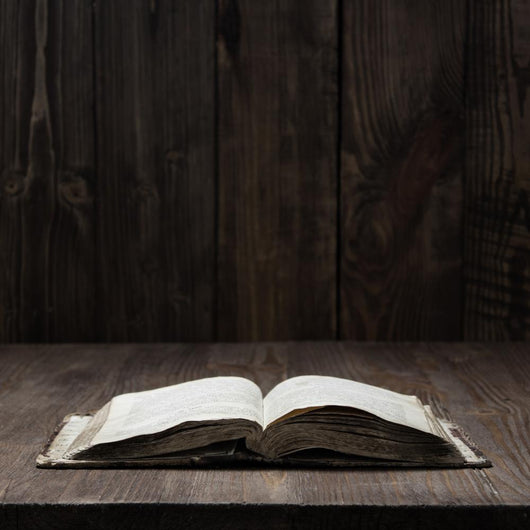 Image of an old  Holy Bible on wooden background on a wooden background in a dark space Wall Mural