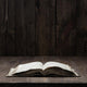 Image of an old  Holy Bible on wooden background on a wooden background in a dark space Wall Mural