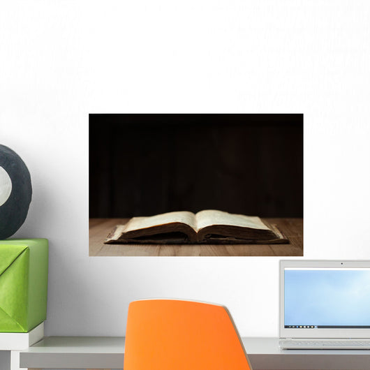 Image of an old Holy Bible on wooden background in a dark space Wall Mural