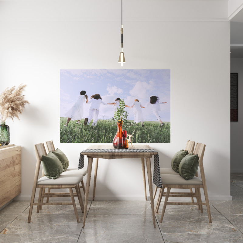 A Decal Poster of a Family on the Wall Next To a Dining Room Table
