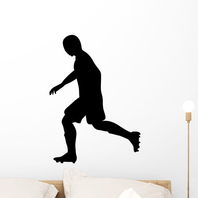 Running Soccer Player Wall Decal shown on a wall