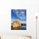 Rock island in a lake with blue sky and clouds Wall Mural