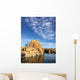 Rock island in a lake with blue sky and clouds Wall Mural
