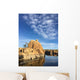 Rock island in a lake with blue sky and clouds Wall Mural