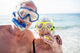 Happy senior couple with their diving mask at beach  Wall Mural