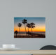 Palm trees on the beach at sunset Wall Mural
