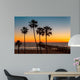 Palm trees on the beach at sunset Wall Mural