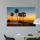 Palm trees on the beach at sunset Wall Mural