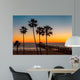 Palm trees on the beach at sunset Wall Mural