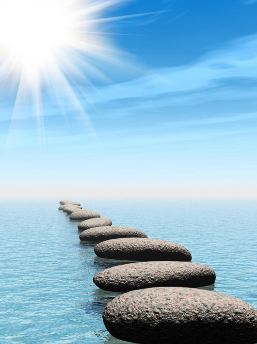 A row of stones in water with sun beam Wall Mural
