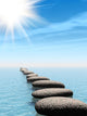A row of stones in water with sun beam Wall Mural