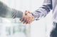 Business partnership meeting concept. Image businessmans handshake. Successful businessmen handshaking after good deal. Horizontal, blurred background Wall Mural