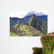 Machu Picchu is located in the Cusco Region of Peru, South America. It is situated on a mountain ridge above the Urubamba Valley in Peru, which is 80 kilometres (50 mi) northwest of Cusco  Wall Mural
