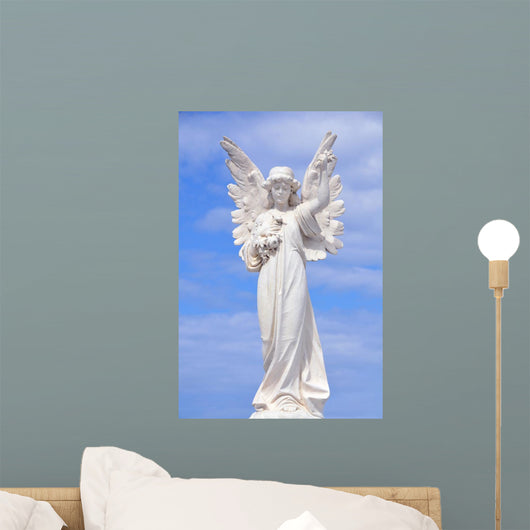 White angel grave yard statue with blue sky Wall Mural