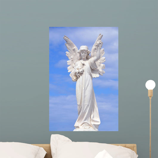 White angel grave yard statue with blue sky Wall Mural