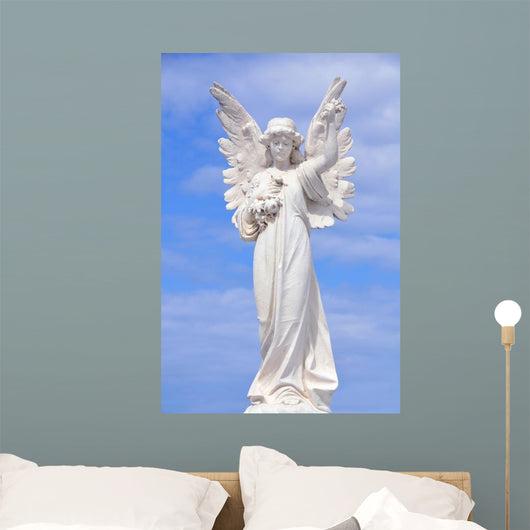 White angel grave yard statue with blue sky Wall Mural