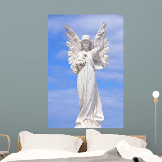 White angel grave yard statue with blue sky Wall Mural