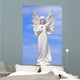 White angel grave yard statue with blue sky Wall Mural