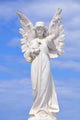 White angel grave yard statue with blue sky Wall Mural