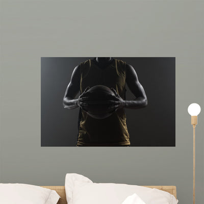 Up Basketball Player Holding Wall Mural shown on a wall